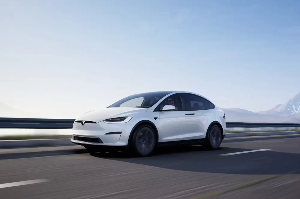 white tesla model X car motion driving