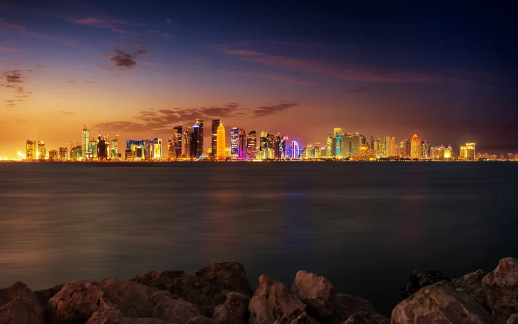 Cityscape Illuminated Skyscrapers Twilight Sky Water Reflection Rocks