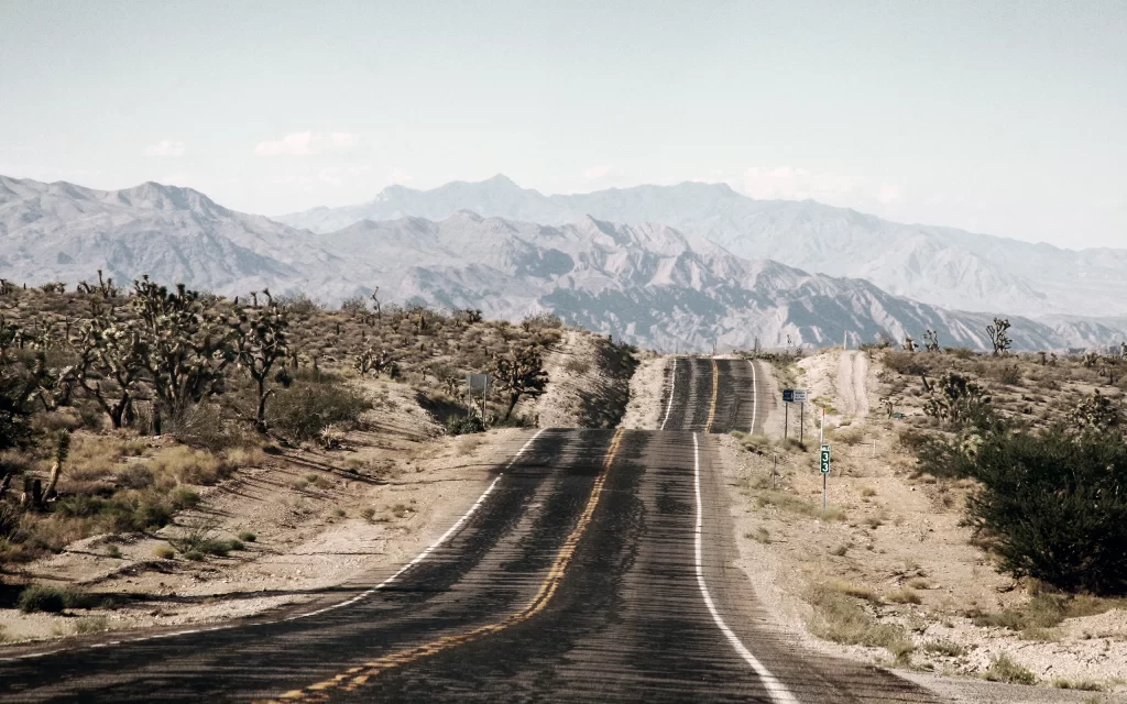 Desert Road Mountains Arid Landscape Scenic View