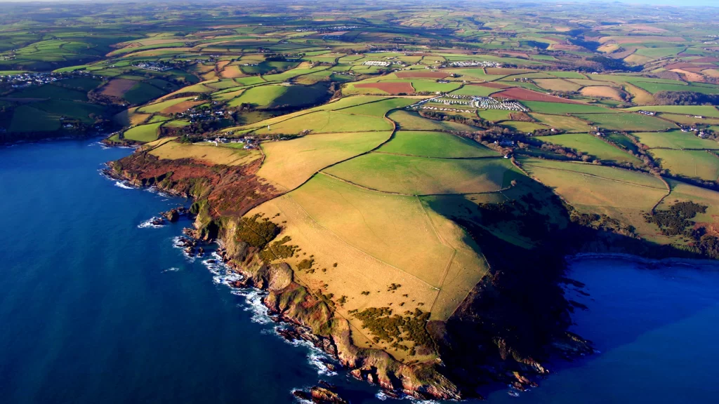 Aerial view coastline green fields rural landscape blue sea natural beauty