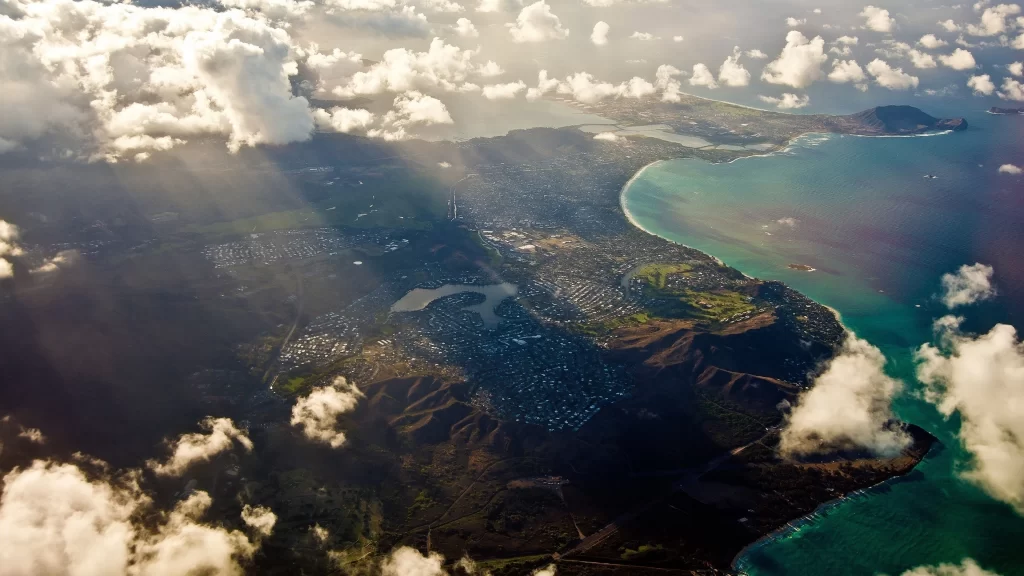 Aerial view landscape ocean coastline clouds sunlight