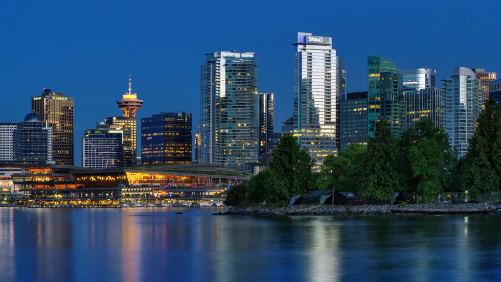 Cityscape skyscrapers waterfront evening lights reflection