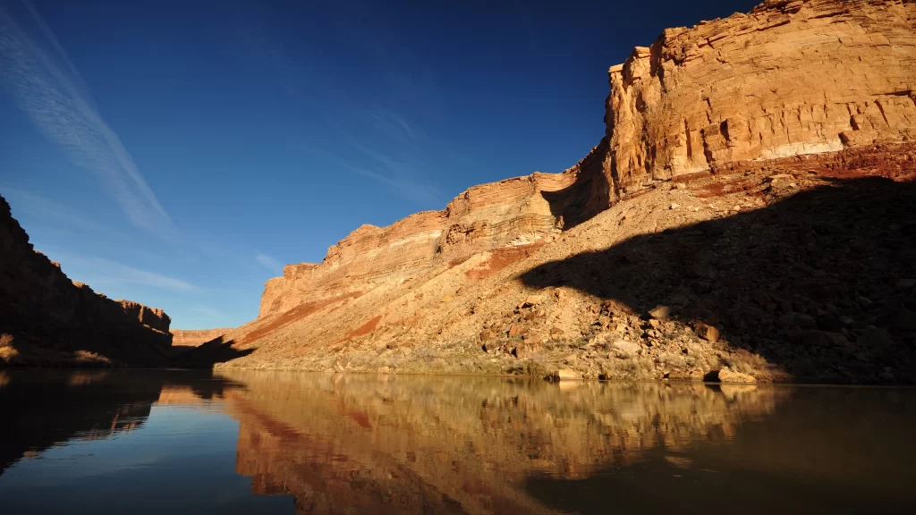 Desert canyon river reflection cliffs sky