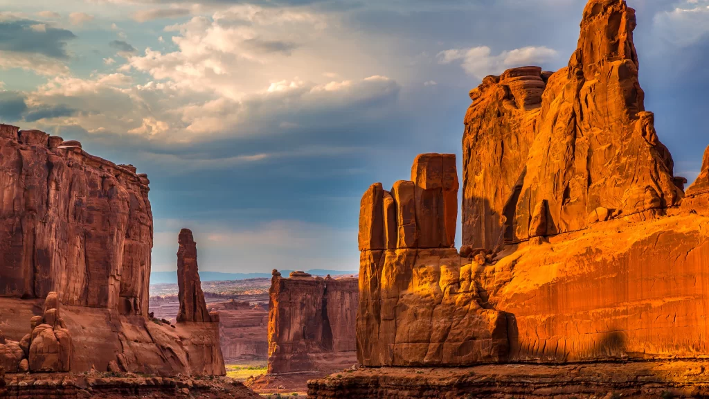Desert rock formations canyon sky clouds sunlight landscape natural beauty