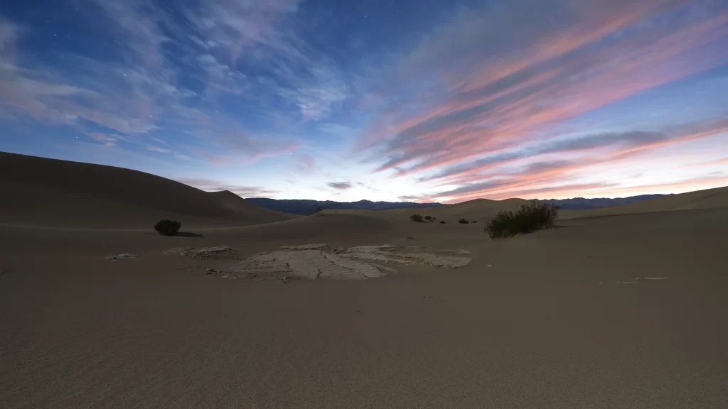 Desert sand dunes sunset sky clouds landscape