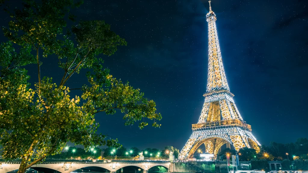 Eiffel Tower night lights bridge trees Paris