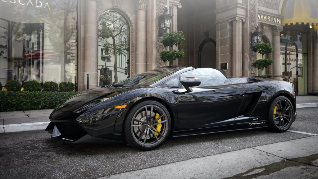 Luxury car black convertible street upscale storefronts