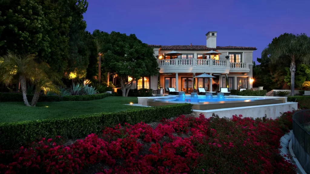 Luxury house swimming pool evening garden lights flowers