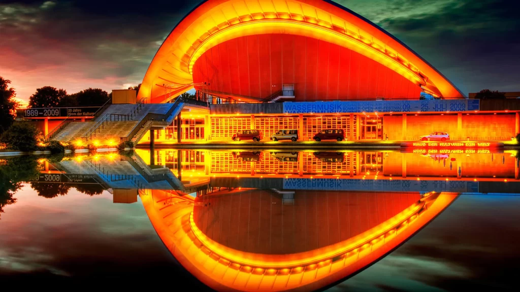 Modern architecture, vibrant colors, reflection, water, sunset, contemporary design