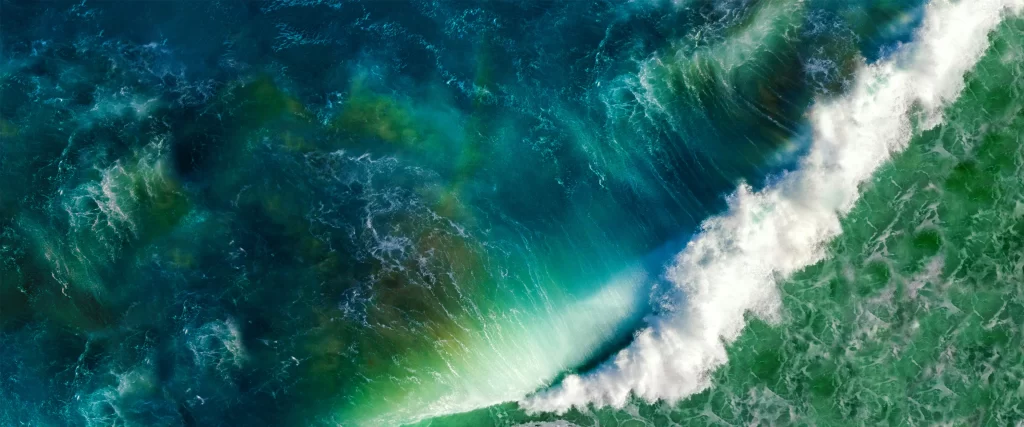 Ocean waves, aerial view, vibrant colors, dynamic motion, natural beauty