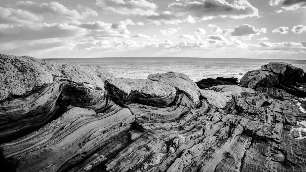 Rocks ocean clouds sunlight waves textures