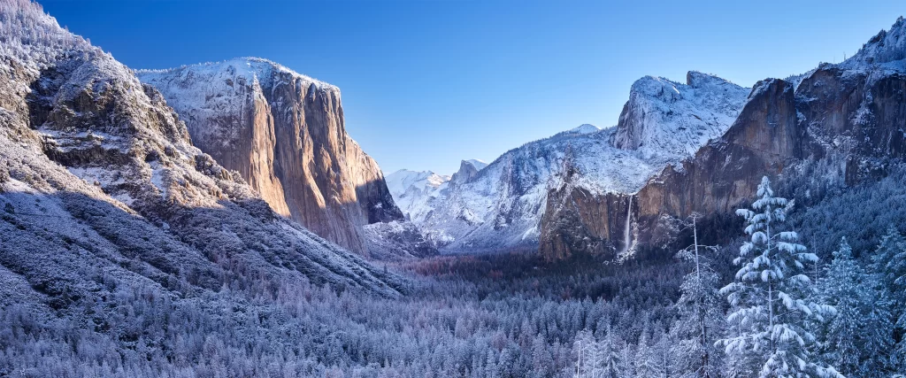 Snowy mountains, clear sky, winter landscape, serene, natural beauty, tranquil