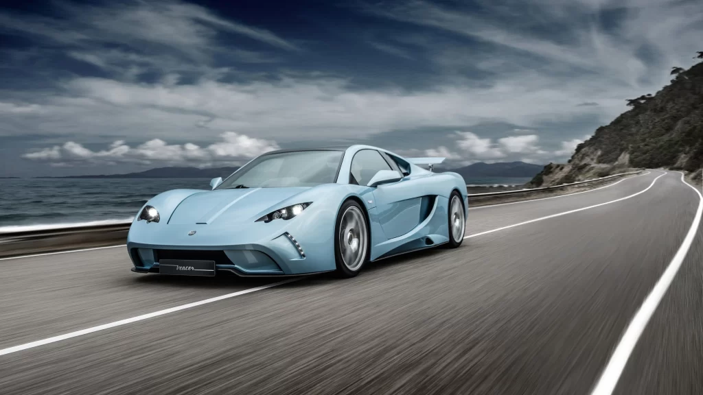 Sports car coastal road ocean view cloudy sky luxury vehicle scenic drive