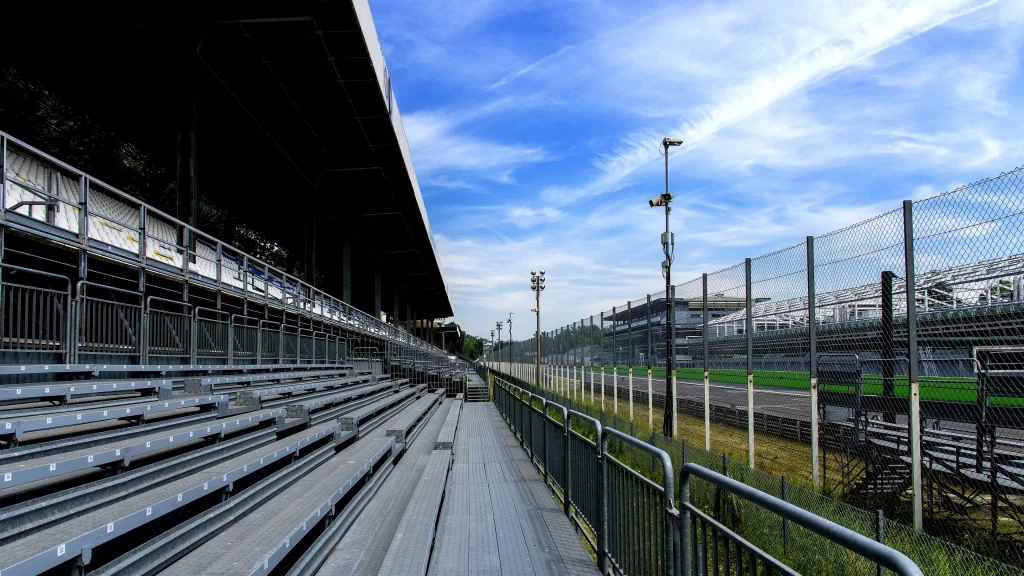 Stadium bleachers empty sky fence grass