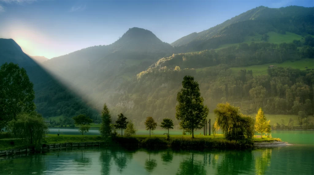 Sunlight mountains lake trees reflection nature