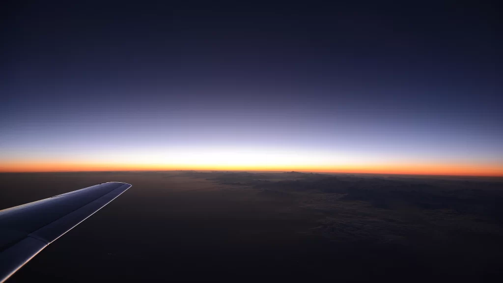 Sunset airplane wing horizon sky clouds