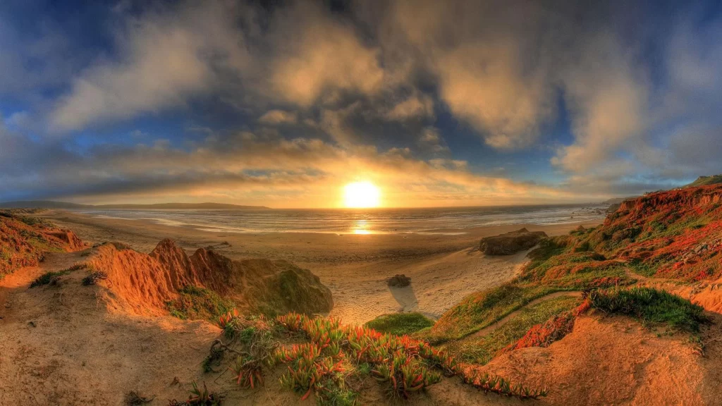Sunset beach cliffs clouds ocean landscape