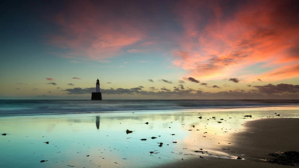 Sunset beach lighthouse clouds reflection tranquil