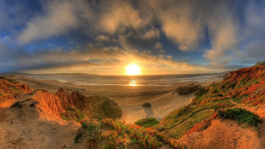 Sunset beach ocean clouds cliffs landscape