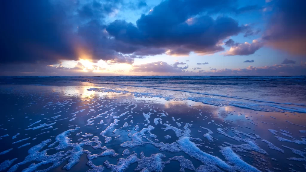 Sunset beach ocean clouds reflection waves