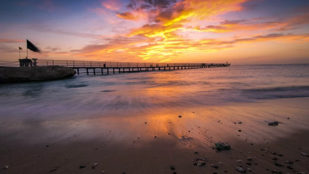Sunset beach pier ocean sky clouds reflection colors