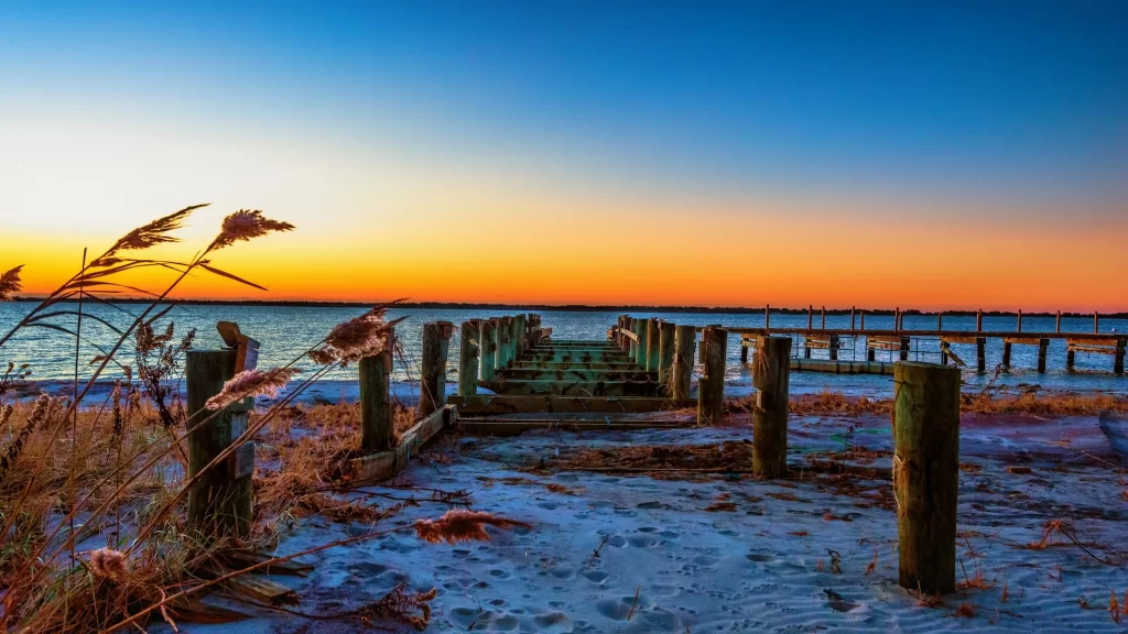 Sunset beach pier ocean sky grass