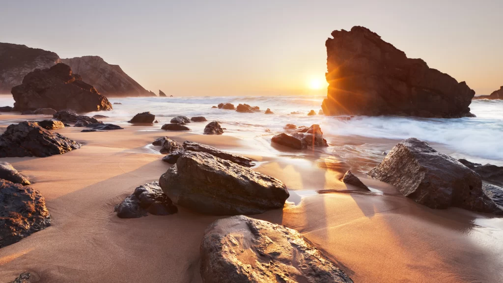 Sunset beach rocks waves sky horizon