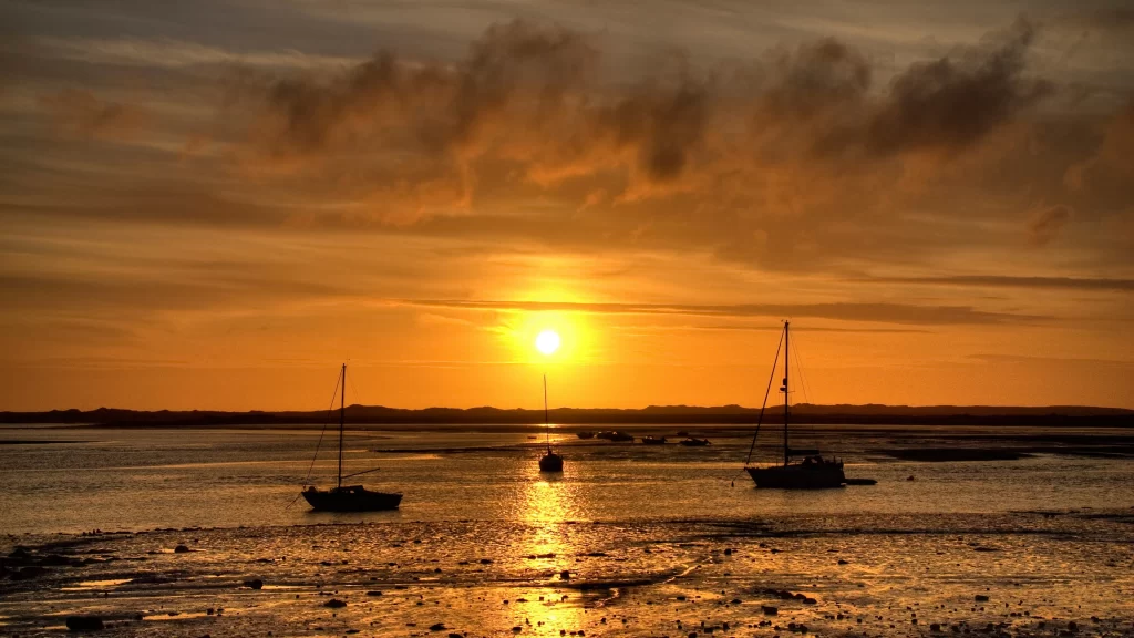 Sunset boats water sky clouds reflection