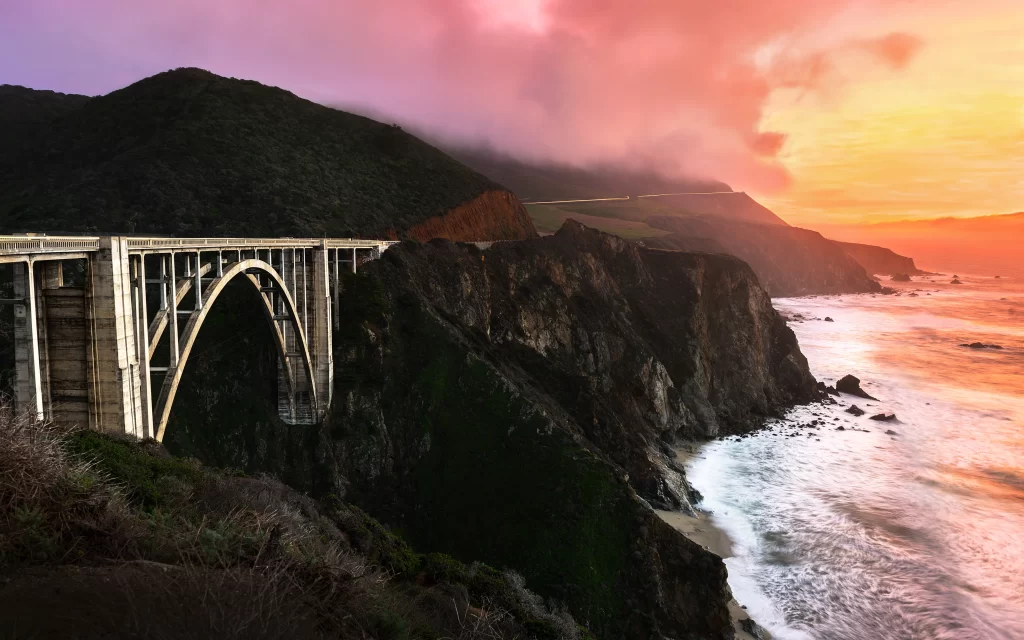 Sunset bridge ocean cliffs landscape twilight