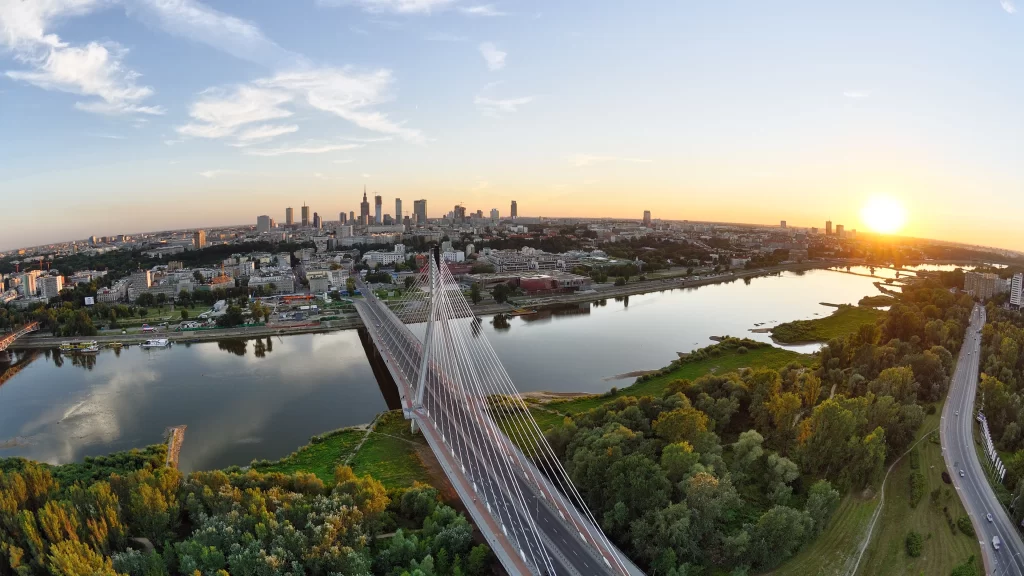 Sunset cityscape bridge river skyline greenery urban architecture