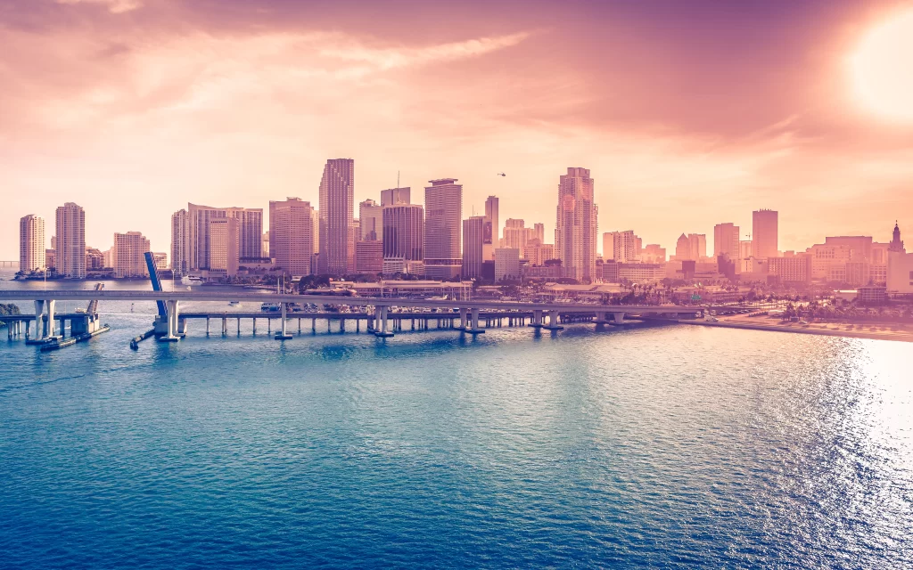 Sunset cityscape bridge water buildings skyline reflection tranquil