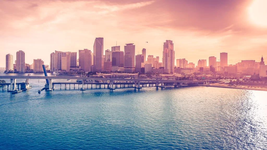 Sunset cityscape bridge water buildings skyline reflection tranquil
