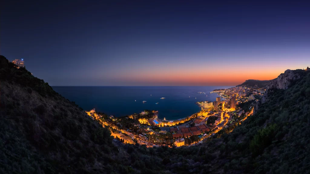 Sunset cityscape coastline ocean lights mountains twilight panorama