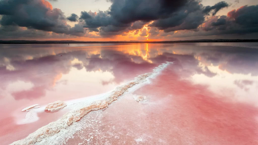 Sunset clouds reflection pink water horizon