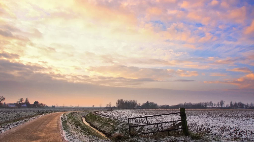 Sunset clouds road field gate frost