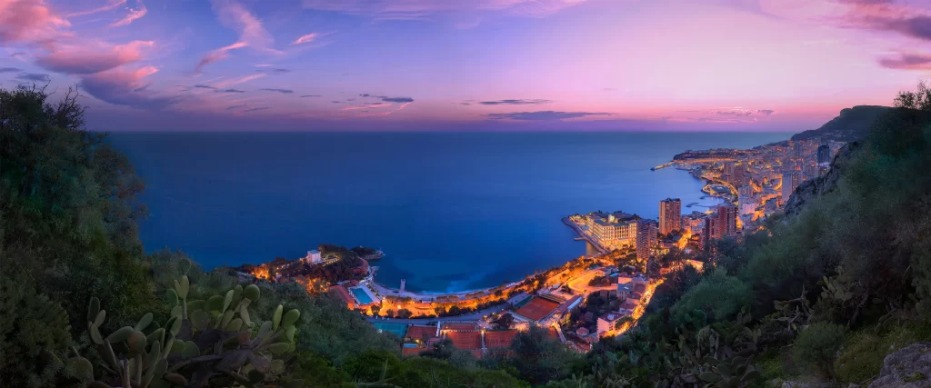 Sunset, coastal city, ocean, buildings, lights, sky