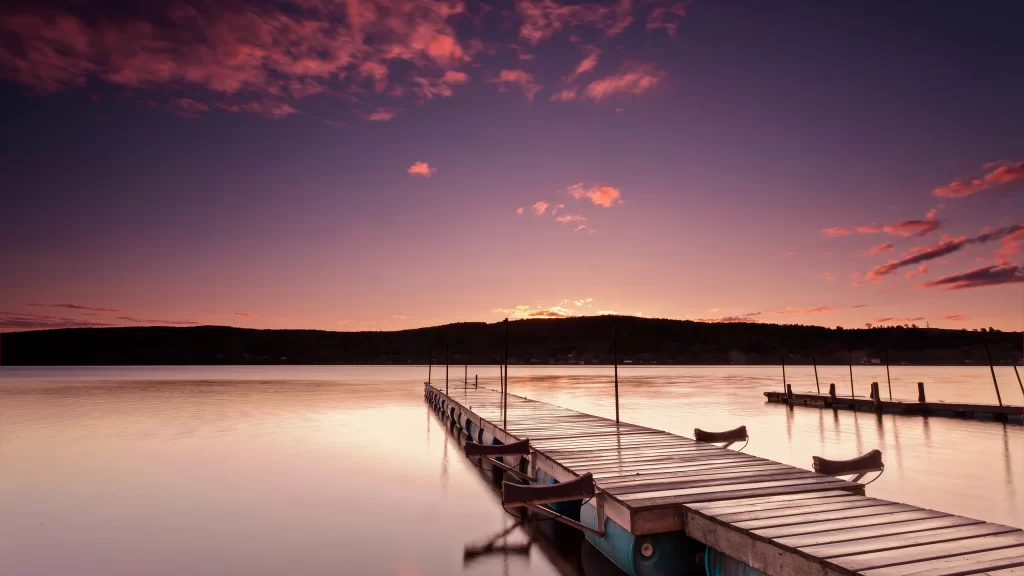 Sunset dock water sky clouds reflection