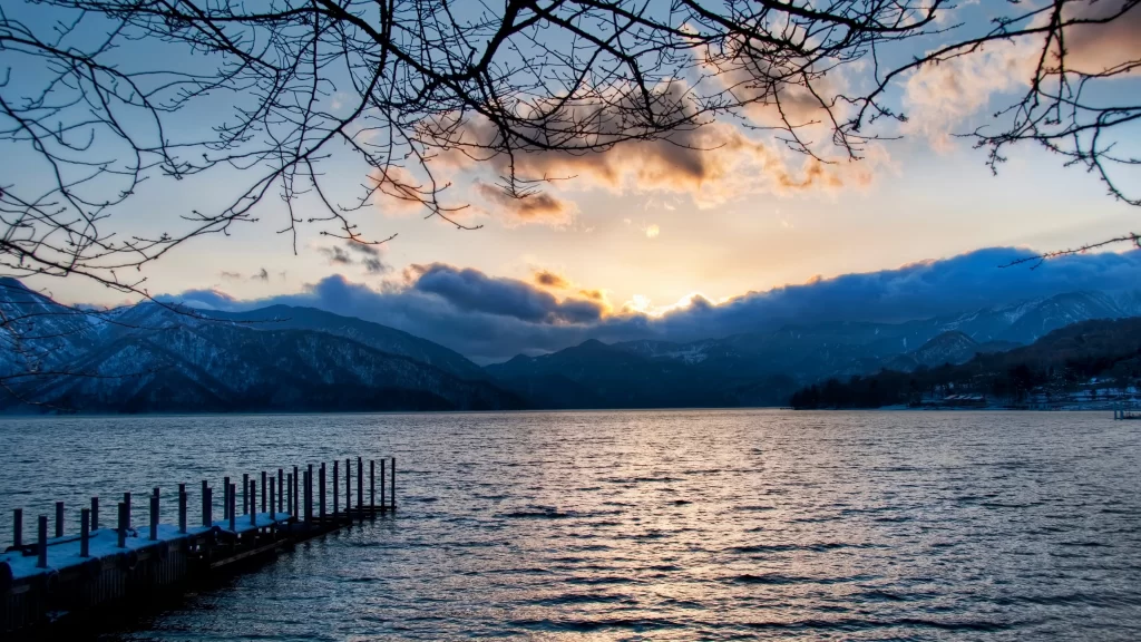 Sunset lake mountains clouds pier reflection