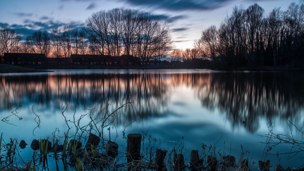 Sunset lake reflection trees clouds sky