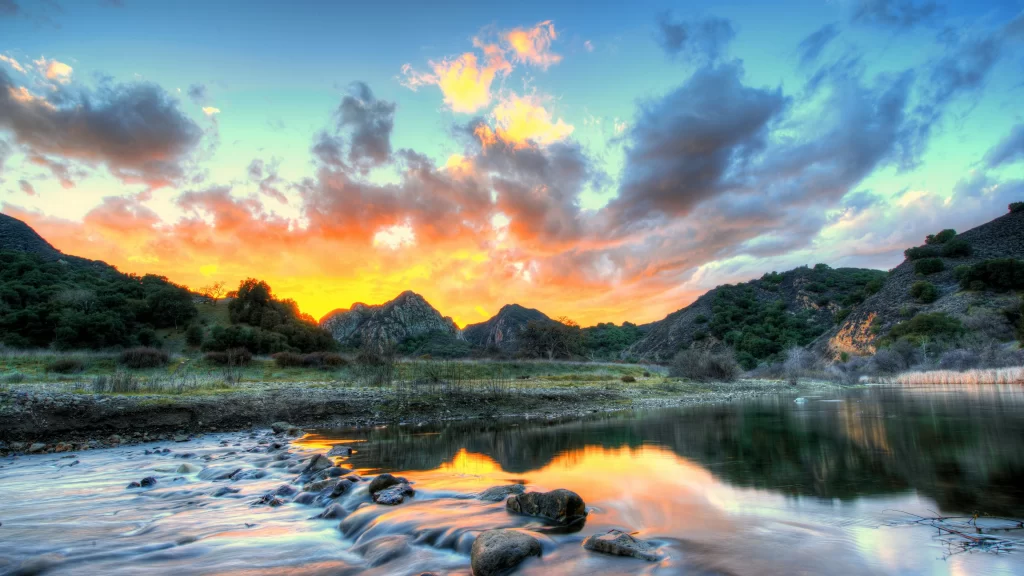 Sunset landscape water reflection mountains clouds