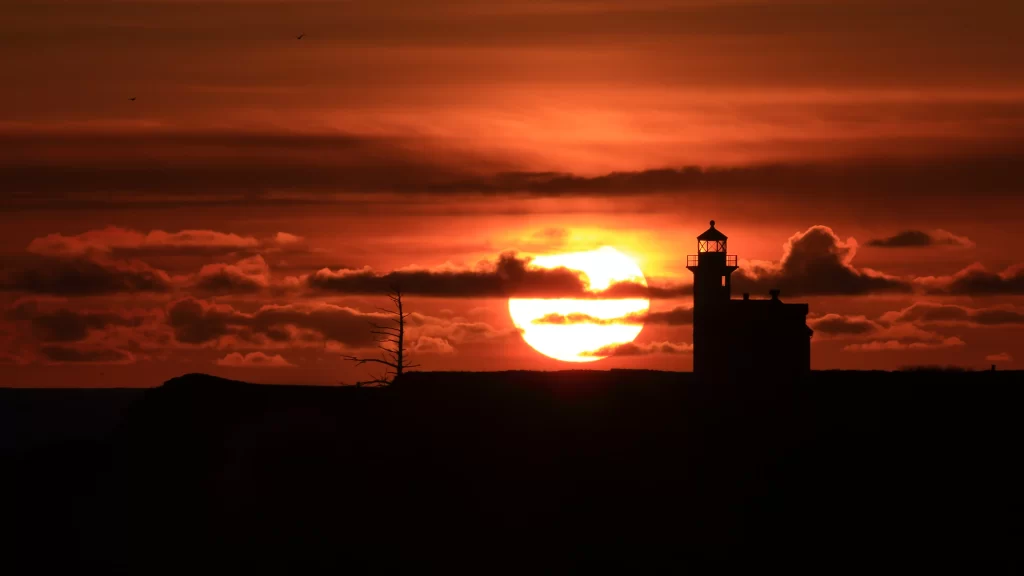 Sunset lighthouse clouds sky silhouette horizon