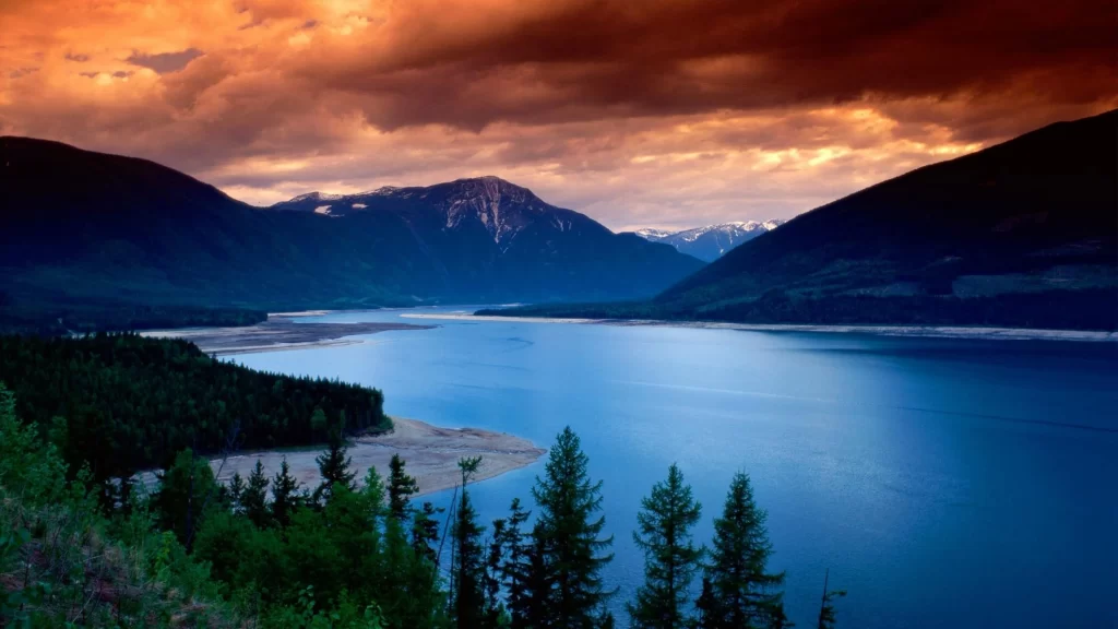 Sunset mountains lake forest clouds reflection