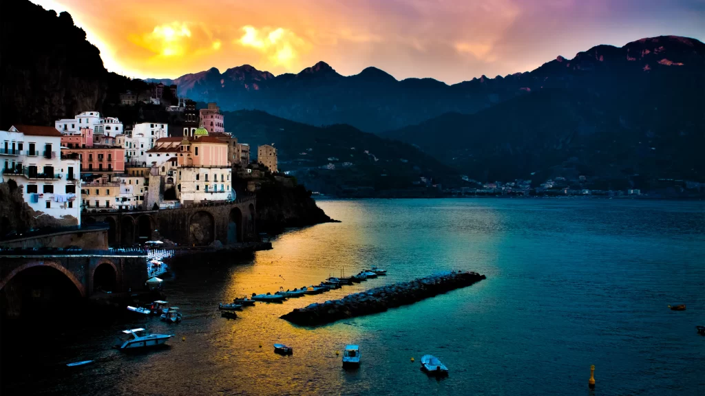 Sunset mountains sea boats buildings sky