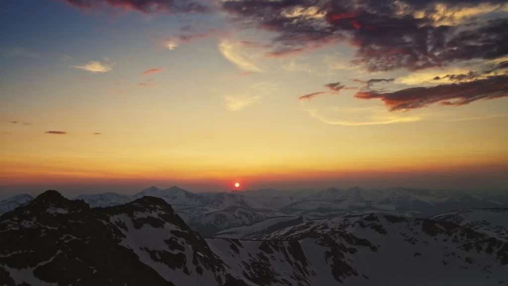 Sunset mountains snow clouds sky landscape