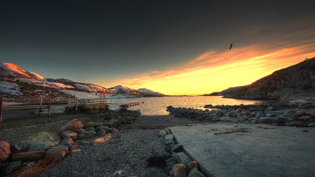 Sunset mountains water rocks sky clouds