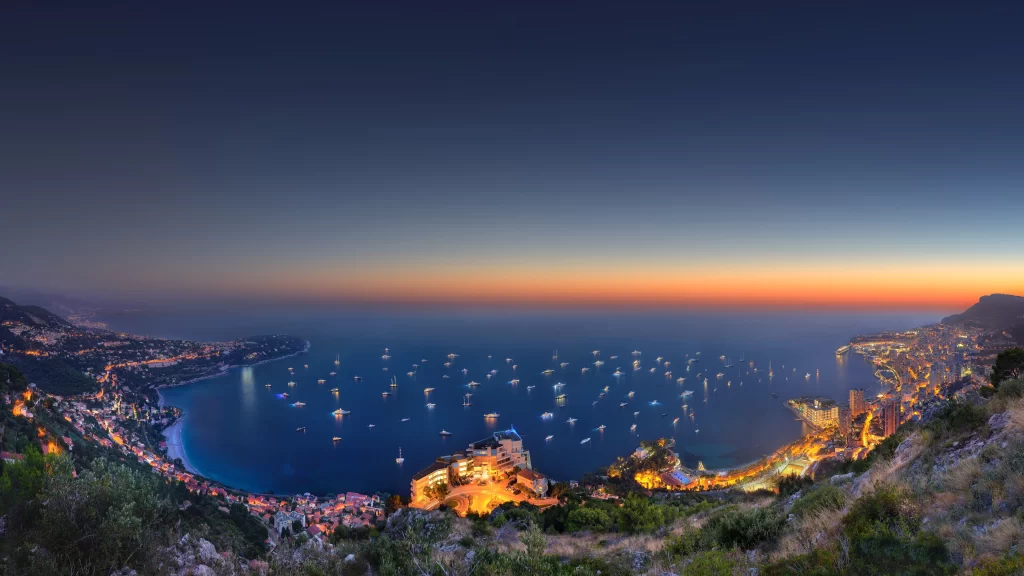 Sunset ocean cityscape boats lights coastline sky horizon