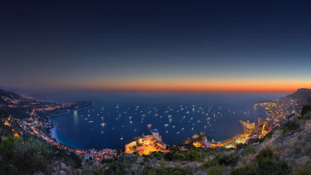 Sunset ocean cityscape boats lights coastline twilight panorama