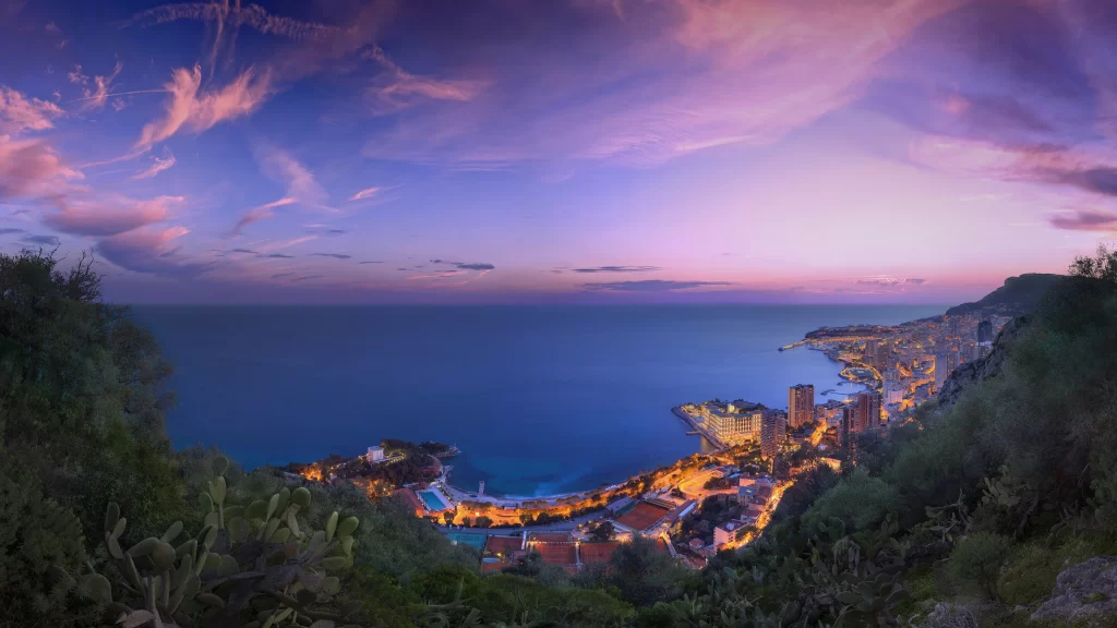 Sunset ocean cityscape coastline clouds twilight buildings lights