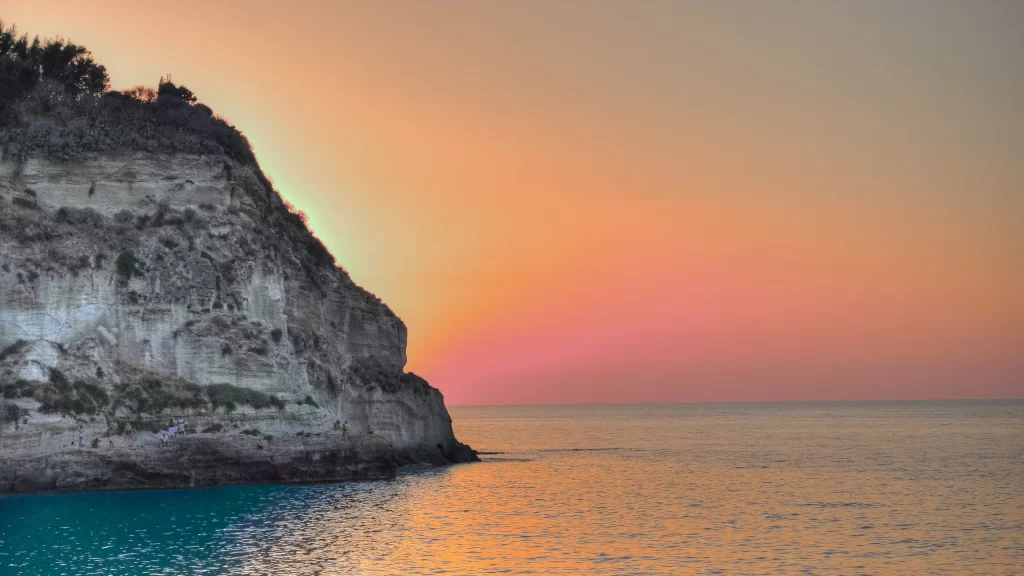 Sunset ocean cliff sky reflection tranquil