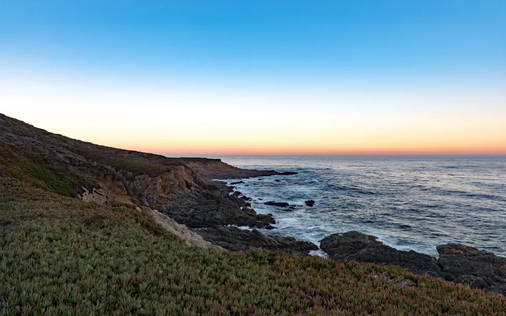 Sunset ocean coastline cliffs waves sky